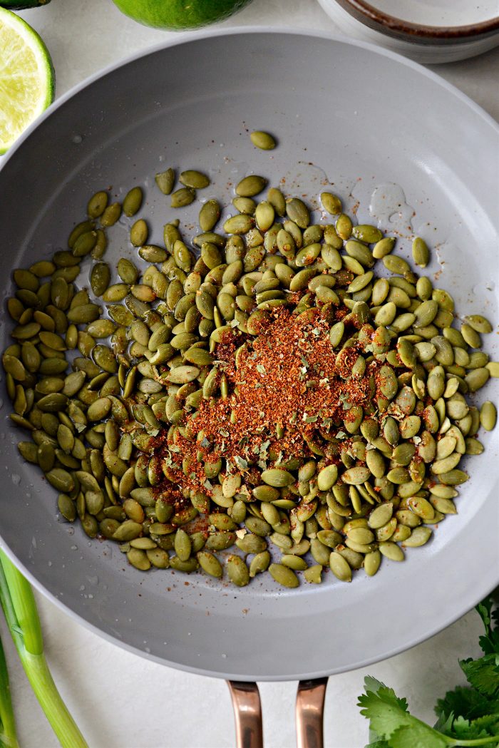 pepitas and seasoning in skillet