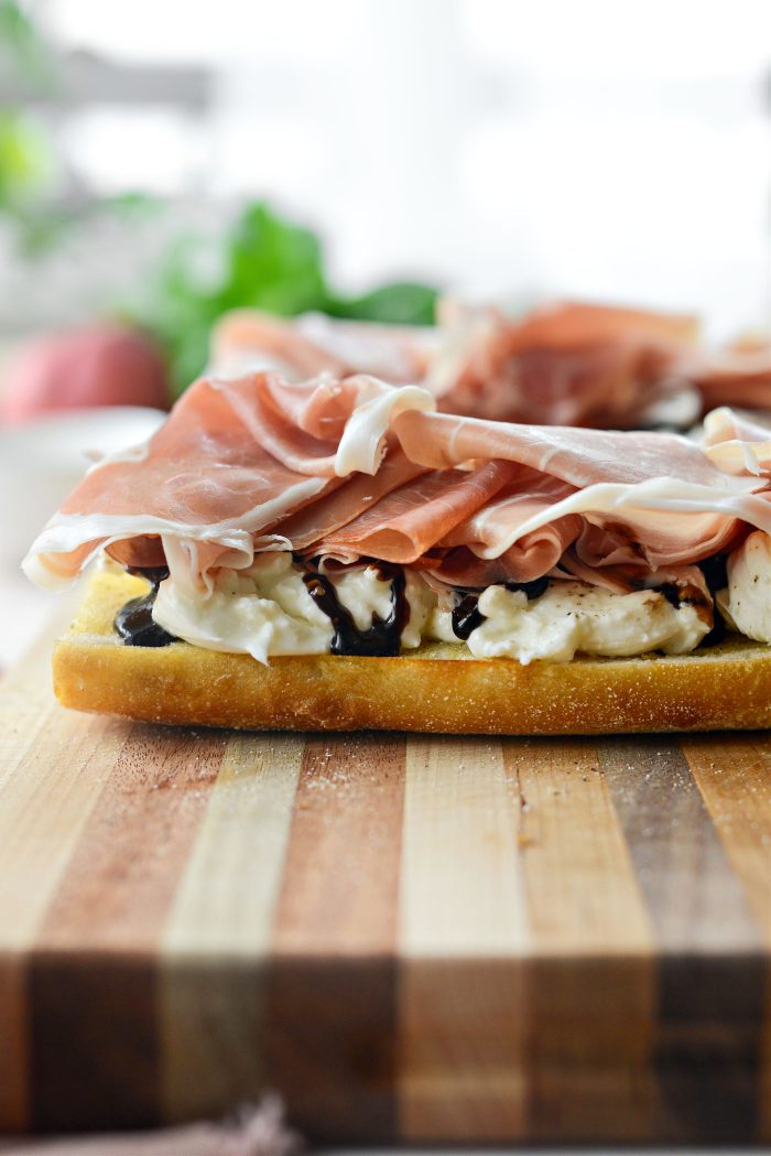 season burrata with black pepper and drizzle with balsamic glaze and top with prosciutto