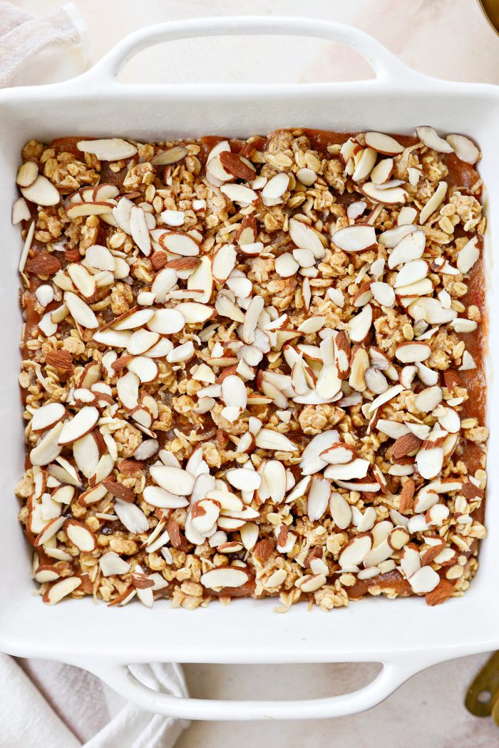 top with remaining crumb mixture and sliced almonds