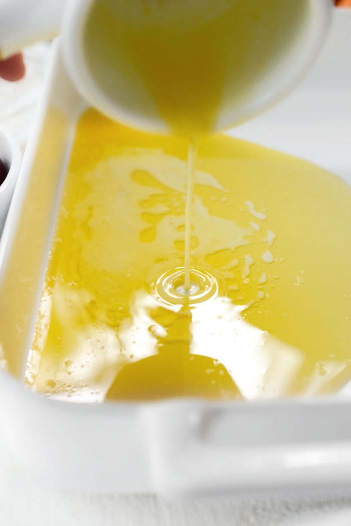 pour melted butter into pan