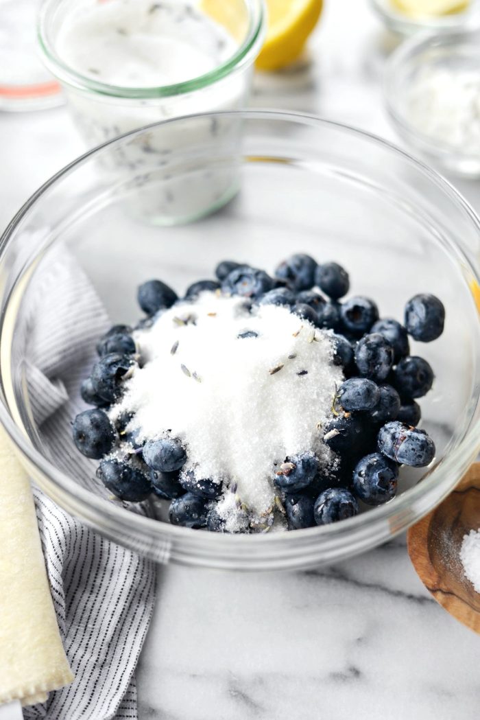 add blueberries and sugar to bowl