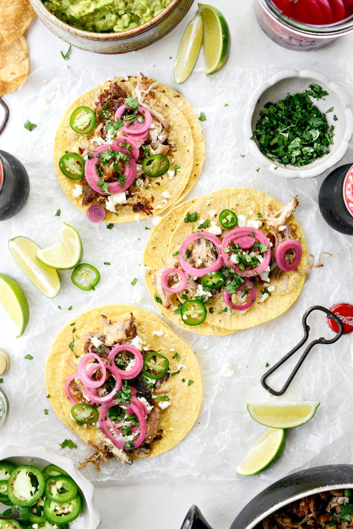 Add carnitas to corn shells and top with cheese, onion and cilantro