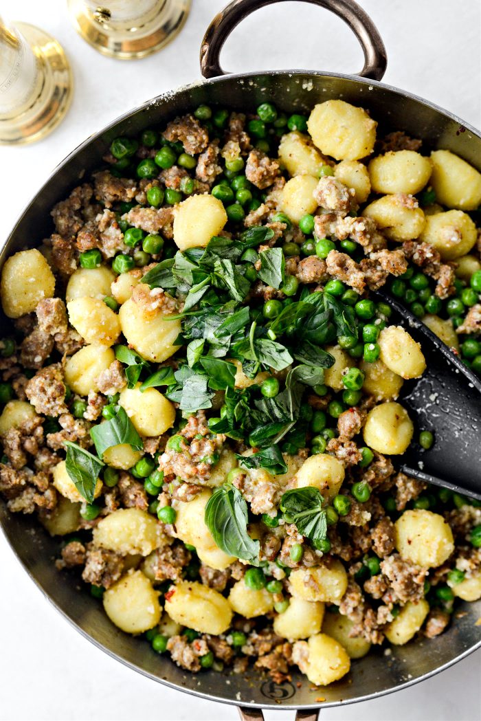 stir and cook until gnocchi are cooked and absorb some of the liquid. then add in torn basil