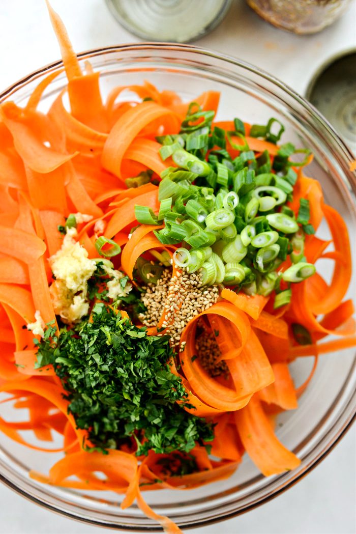 add green onions, cilantro, toasted sesame seeds and garlic