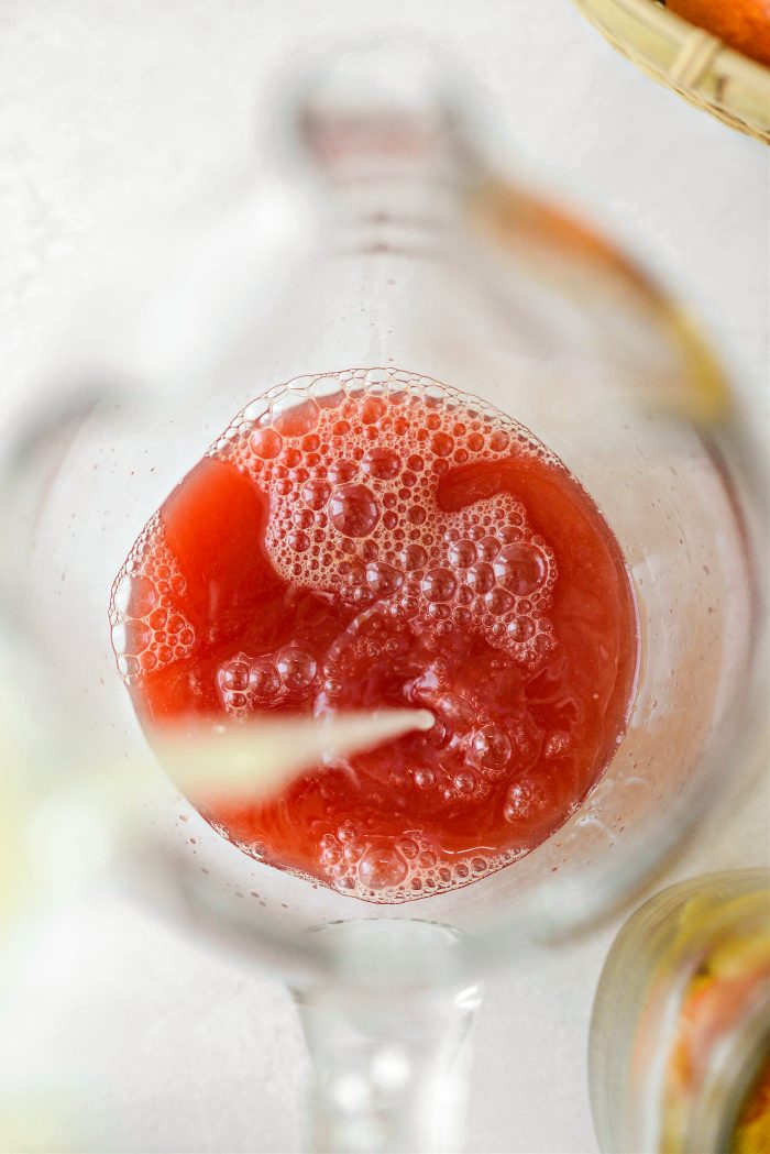 pour lemon and blood orange juice into pitcher and add in syrup