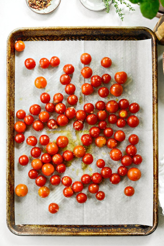 add tomatoes and thyme to prepared baking sheet