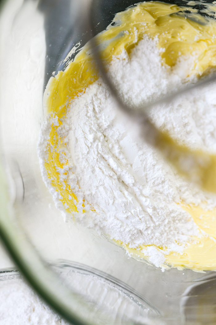 gradually add in sifted powdered sugar