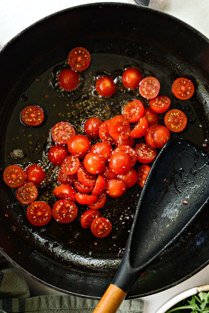add cherry tomato halves and salt and pepper to fat in the pan