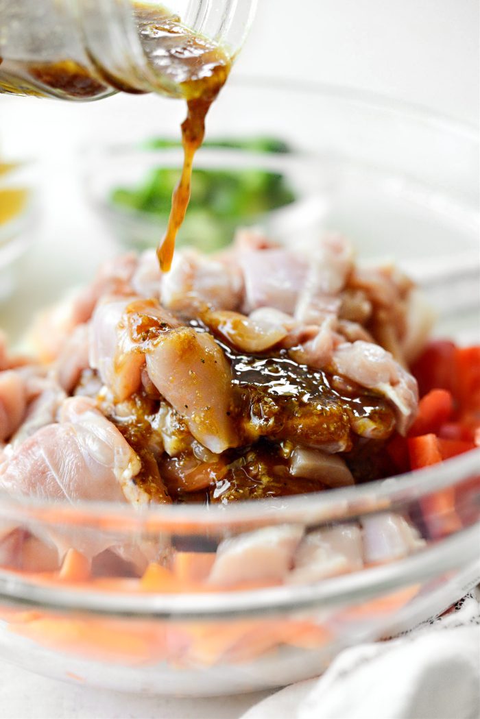 pour half of the marinade/sauce over top of chicken and veggies