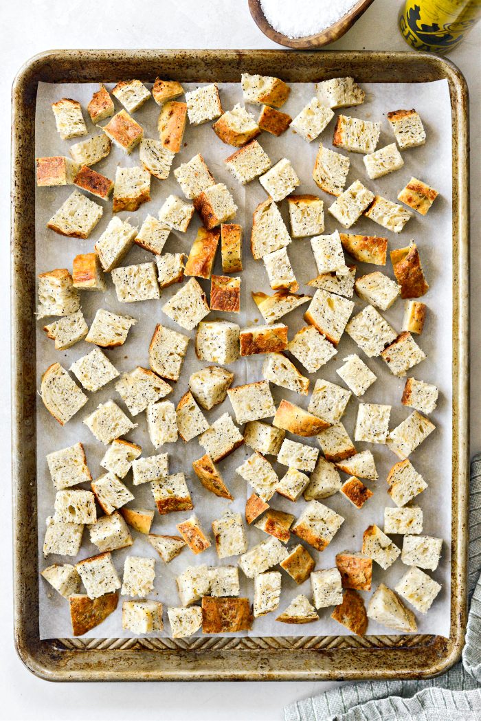 add bread cubes, spray with oil and season with salt