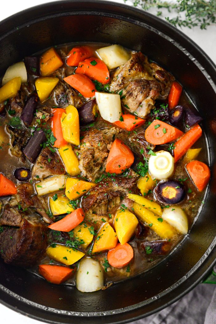 Cider Braised Pork Shoulder in pot with parsley