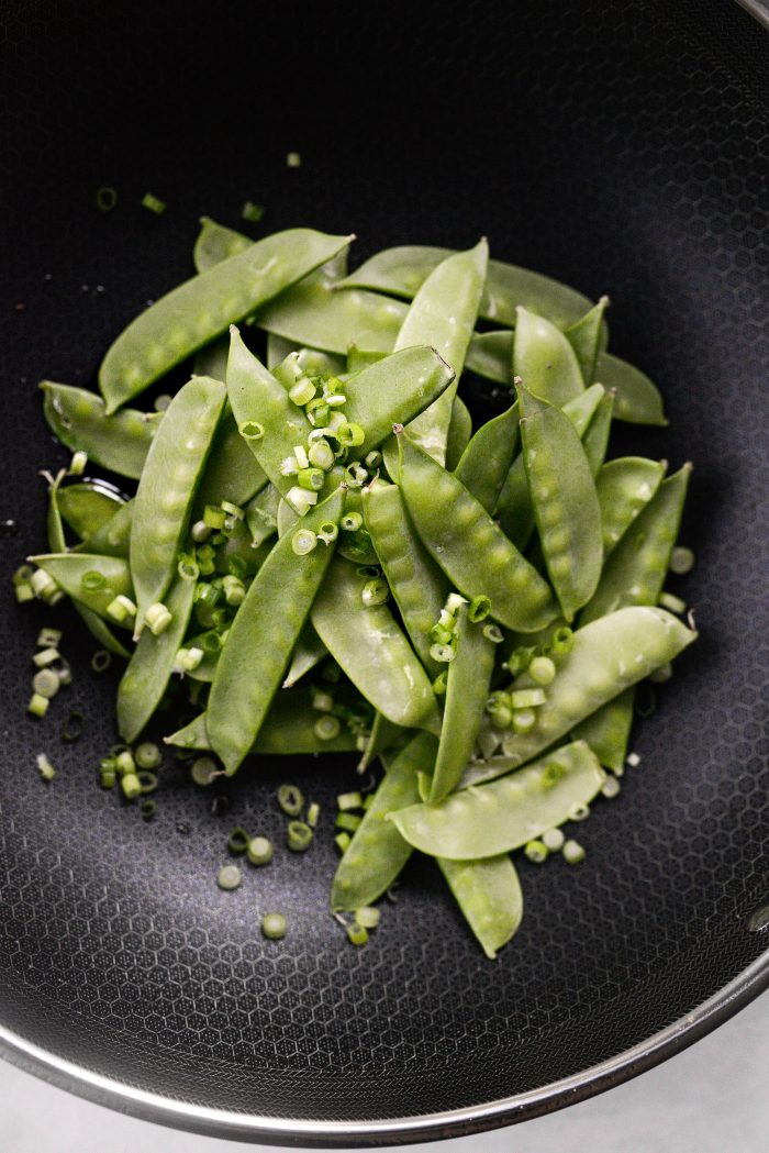 add snow peas and half of the green onions