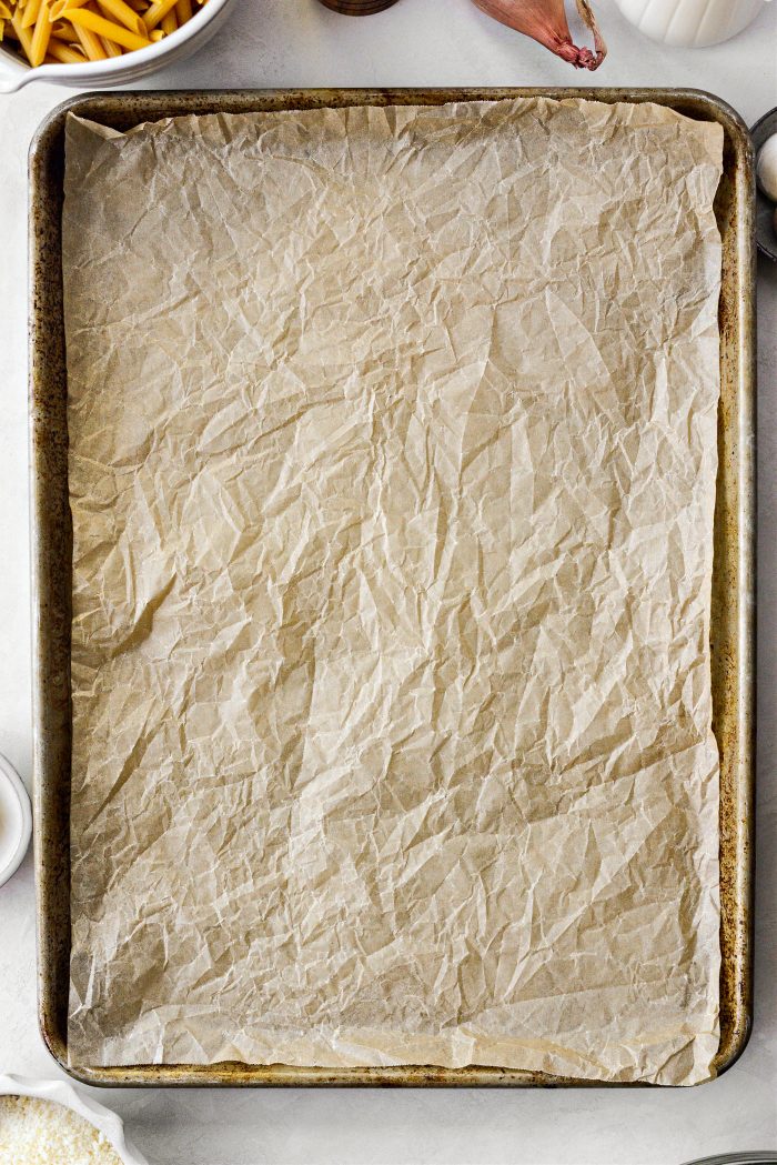preheat oven and line a rimmed baking sheet with parchment 