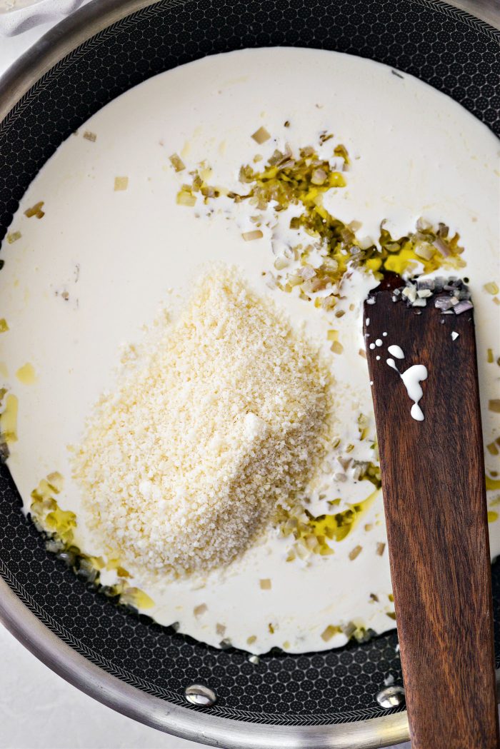 pour in cream and add in parmesan cheese