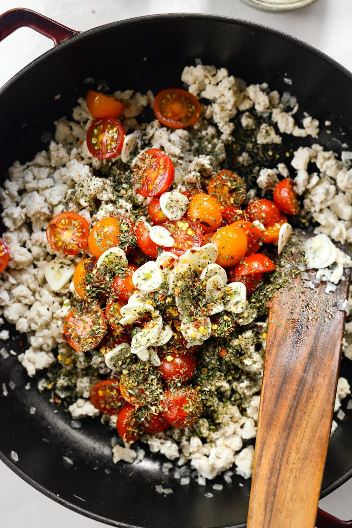 Once fully cooked, add tomatoes, garlic, Italian seasoning, salt and red chili flakes.