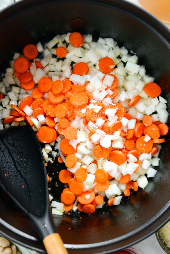 add onions and carrots with a pinch of salt to the pot