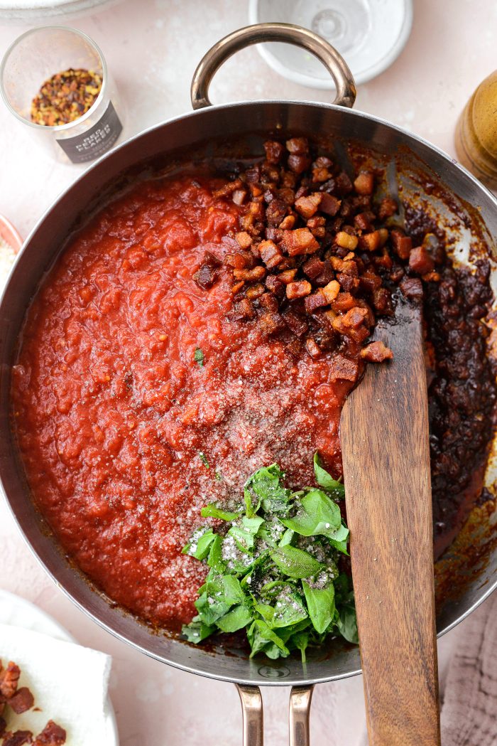 add in tomato sauce, half the pancetta, basil, salt and pepper