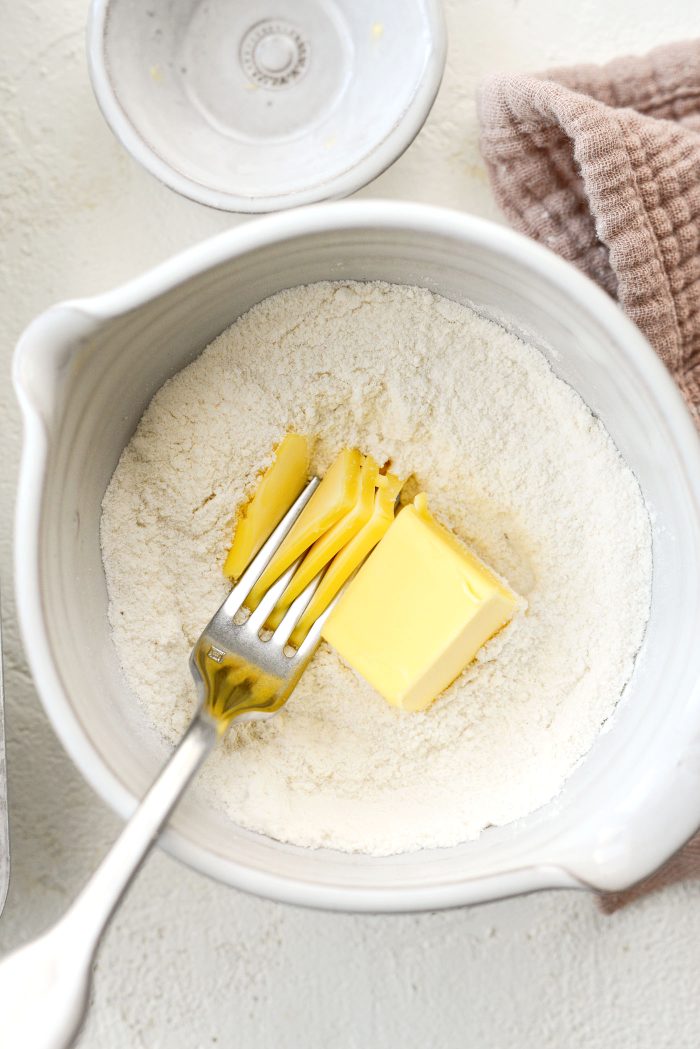 Add butter and use a fork to cut it into the dry ingredients