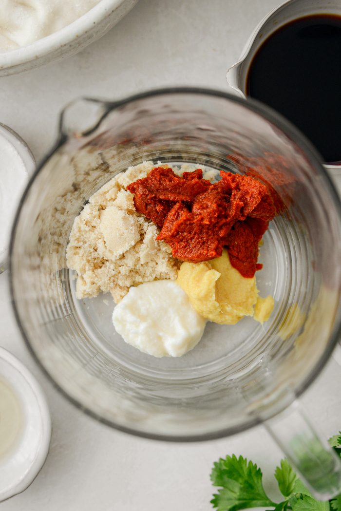 Thai red curry paste, light brown sugar, garlic and ginger paste in a bowl