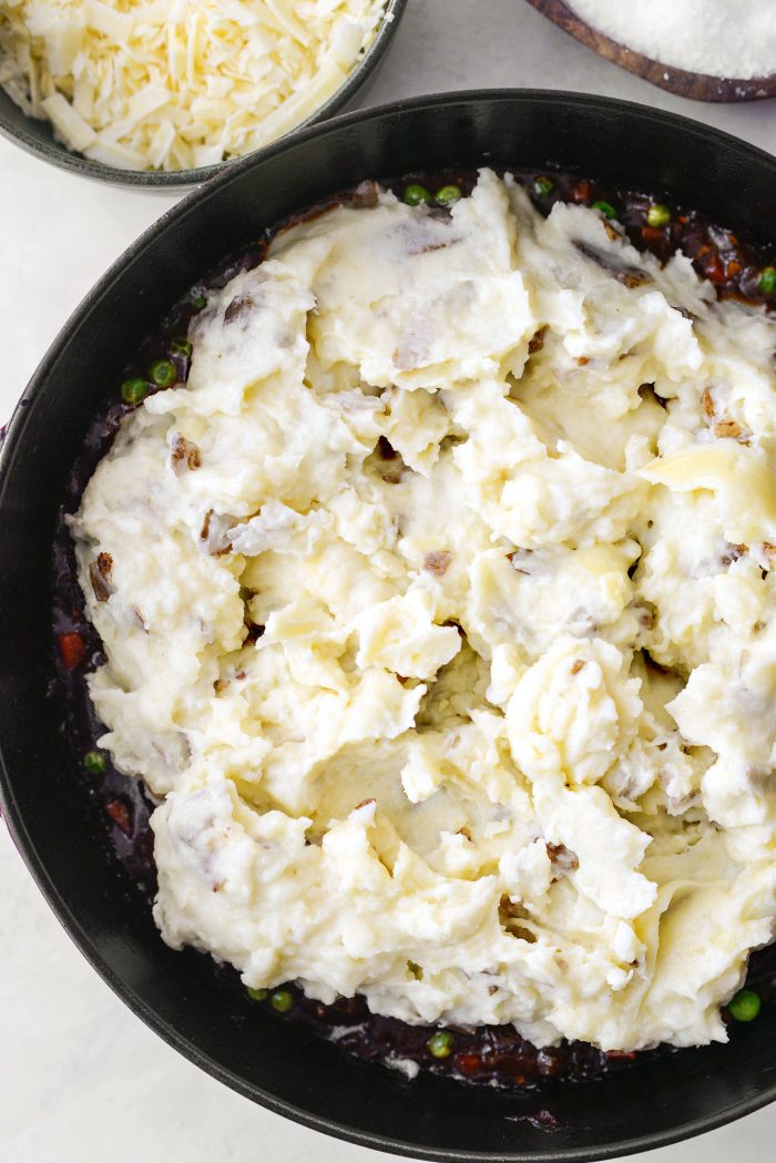 top beef mixture with cheesy mashed potatoes