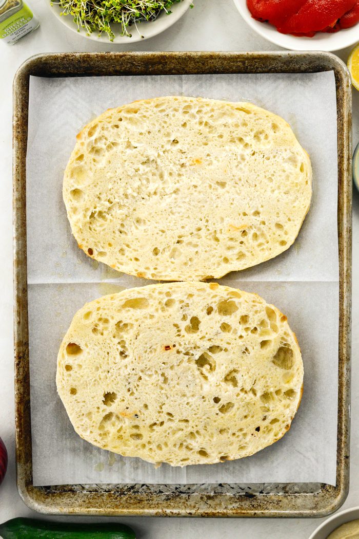 slice focaccia in half and place on lined rimmed pan