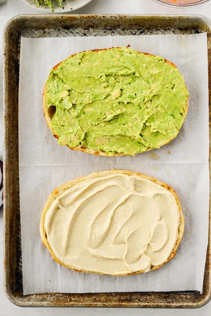 top bottom with hummus and top half with smashed avocado