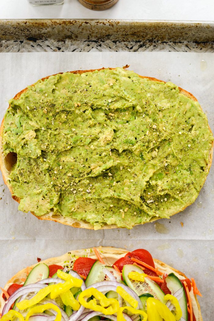 sprinkle smashed avocado with seasoning and black pepper