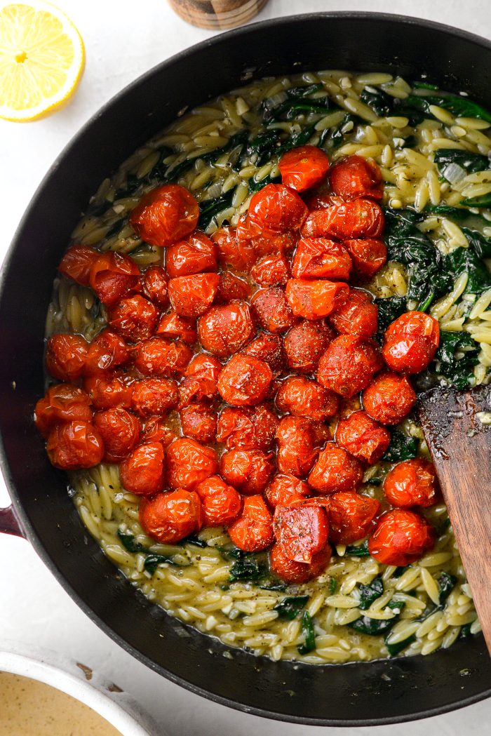 add blistered tomatoes and their juices to the orzo