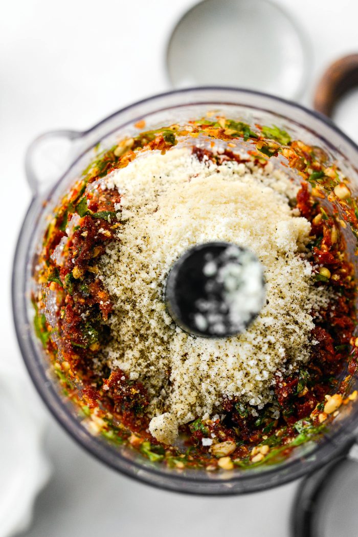 Add in more oil, lemon juice, parmesan, salt, sugar, and freshly ground black pepper.