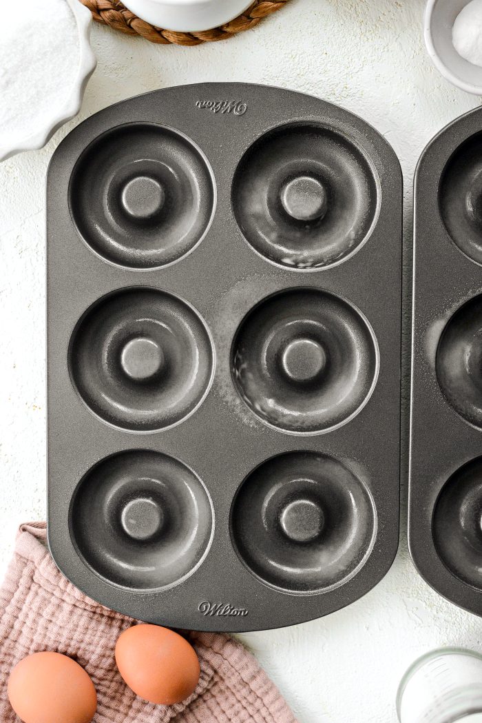 preheat oven and spray doughnut pans with baking spray
