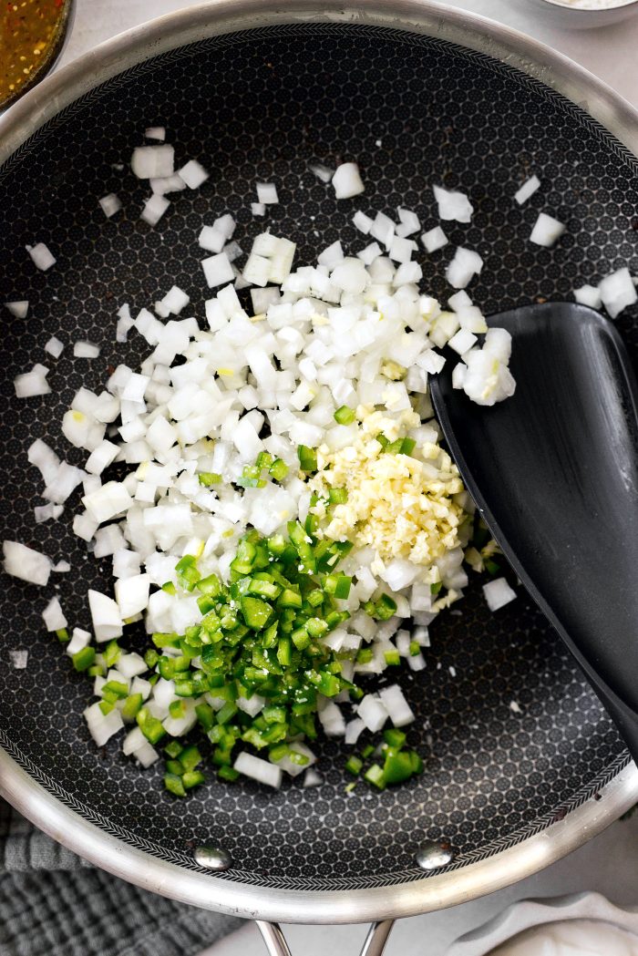 to the pan add oil, onion, jalapeño, garlic and a pinch of salt