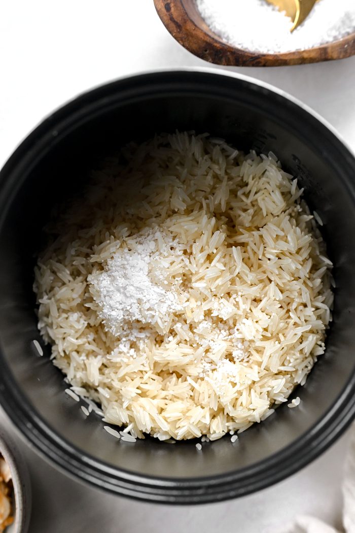 add rice and salt to rice cooker