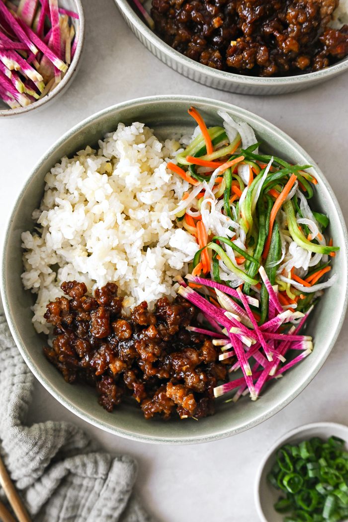 add cauliflower sushi rice, veggies and pork in bowl